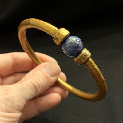Profile view of the replica Egyptian gold bracelet emphasizing the textured gilded finish.
