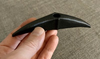 Side profile of the replica demonstrating the raised central ridge and crescent shape.