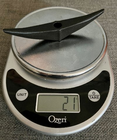 The replica resting on a digital scale indicating a total mass of 21 grams.