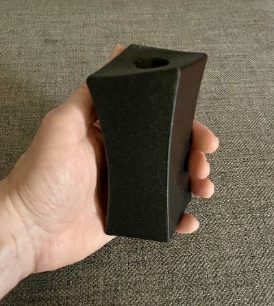 Frontal angled view of the replica resting securely in an open hand.