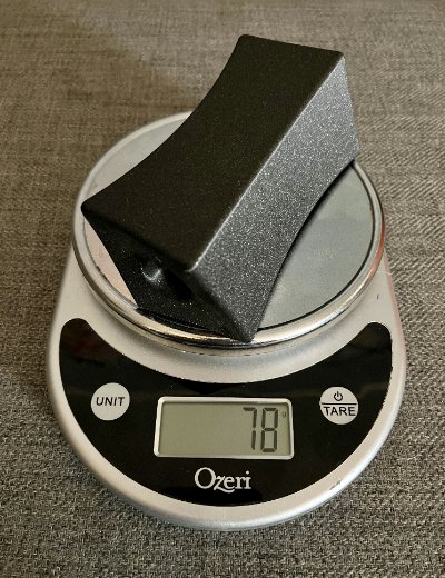 The replica artifact displayed on a digital scale showing a 78-gram weight.