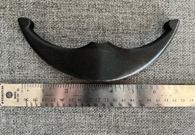 The bannerstone replica positioned beside a ruler confirming its 17.8 centimeter length.