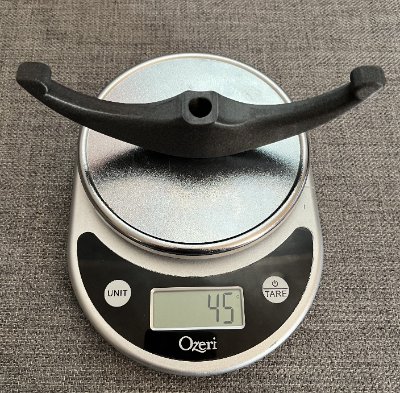 The replica artifact resting on a digital scale indicating a total mass of 45 grams.