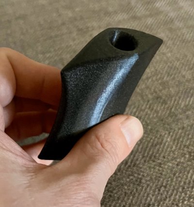 Angled view of the black bannerstone replica showcasing its fluted surface.
