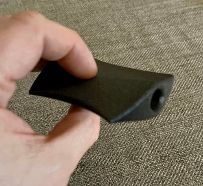Angled profile view of the replica illustrating its curved lateral edges and smooth surface finish.