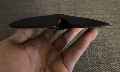 Horizontal lateral view held by a handler to exhibit the tapering thickness of the replica wings.