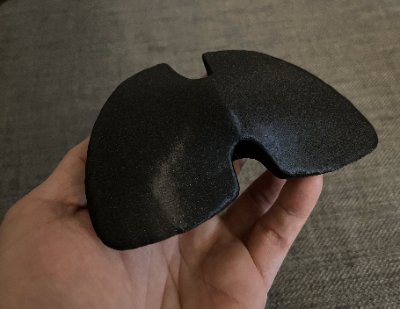 Oblique superior perspective of the replica in hand, illustrating the composite surface texture.