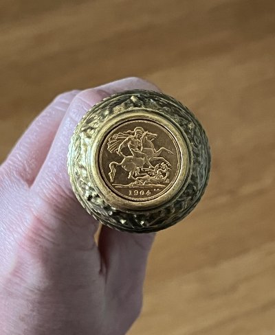Base of the replica staff revealing the metal inset 1904 British Sovereign replica coin.