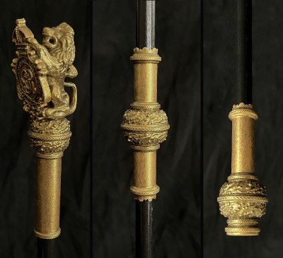 Disassembled components of the replica Black Rod showing head, collar, and base.