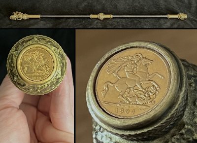 Detailed view of the replica 1904 British Sovereign coin inset in the base alongside reference images.