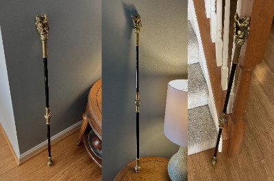 Full-size replica Black Rod standing upright against a residential staircase.