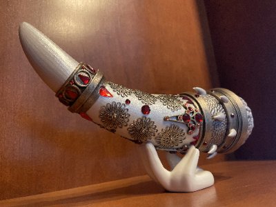 Left-side profile of the jeweled Conan the Destroyer horn replica resting on its display stand.