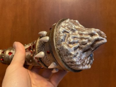 Close-up of the replica horn's textured base simulating the carved biological root structure.