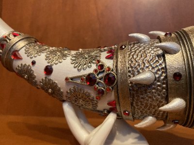 Detailed macro view of the replica horn resting on a stand, focusing on the gemstone clusters.