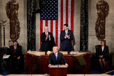 Wide shot of the U.S. House chamber with the wall fasces visible behind the rostrum.