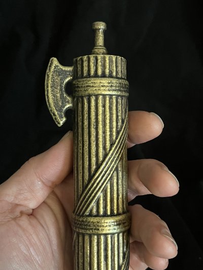 Close-up of the upper section held in hand highlighting the axe blade.
