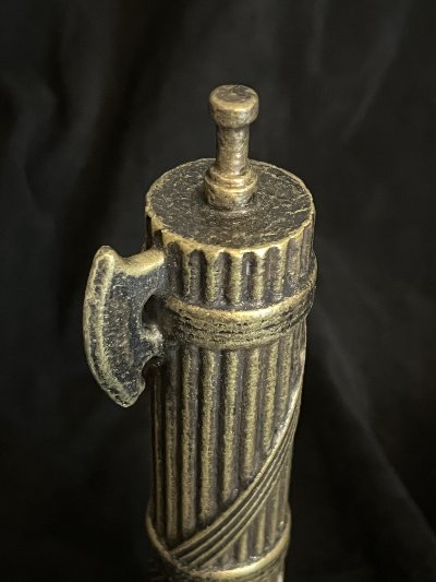 Detailed angle of the upper binding straps and protruding axe head.