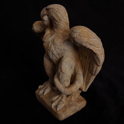 Front-left three-quarter view of the full Roman eagle replica sculpture against a dark background.