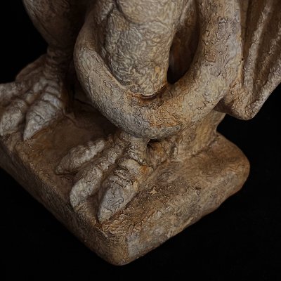 Detailed view of the eagle's talons gripping the snake upon the rectangular plinth base.