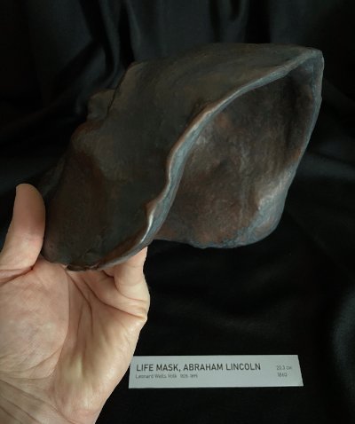 Profile view of the hollow interior cavity of the life mask held in hand.