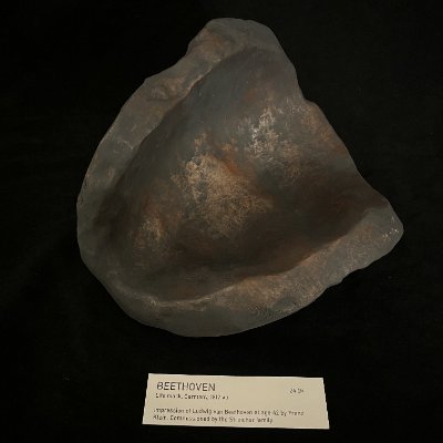 An angled view reveals the hollow interior shell of the replica resting on a surface.