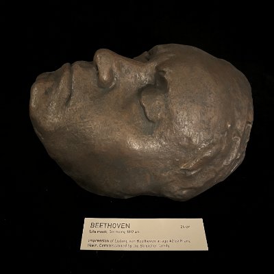 The reconstituted limestone replica lies face-up on a dark surface above its tag.