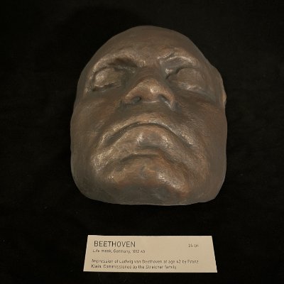 A direct frontal view showcases the realistic facial features of the Beethoven mask.
