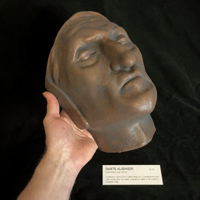 Inferior view of the mask supported by a hand, detailing the jaw and neck contours.