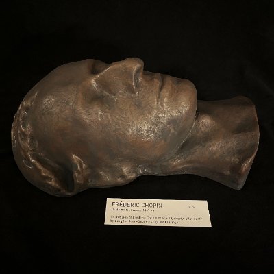 Left profile of the Chopin replica lying flat on its back with museum tag.