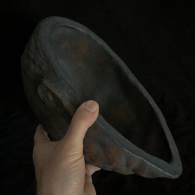 An interior view reveals the hollow cavity and thickness of the shell.