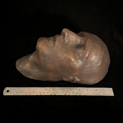 Right profile of the Napoleon death mask displayed alongside a ruler for size reference.