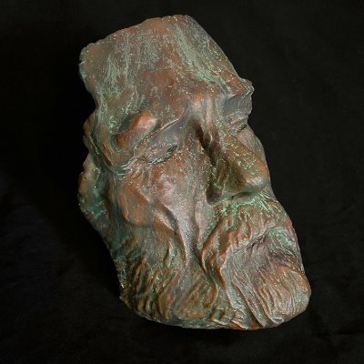 Three-quarter frontal view of the face mask showcasing the oxidized bronze finish.