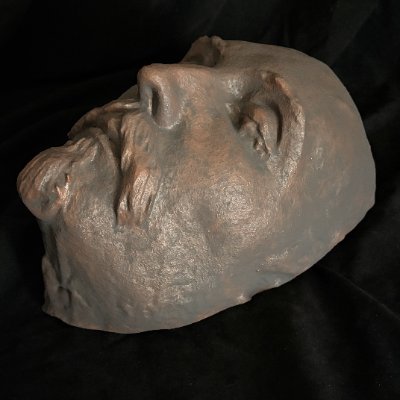 Three-quarter left profile view of the Shakespeare death mask resting flat.