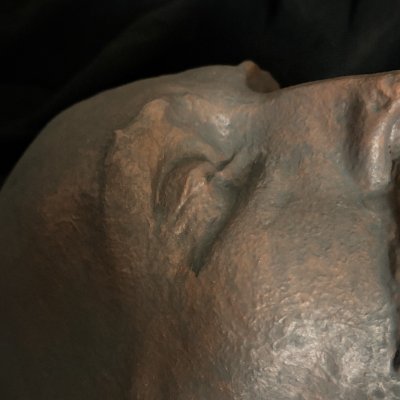 Close-up detail of the forehead and closed eyes of the Shakespeare mask.