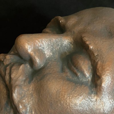 Close-up detail of the closed eyes and nose of the bronze-finished Tchaikovsky replica.