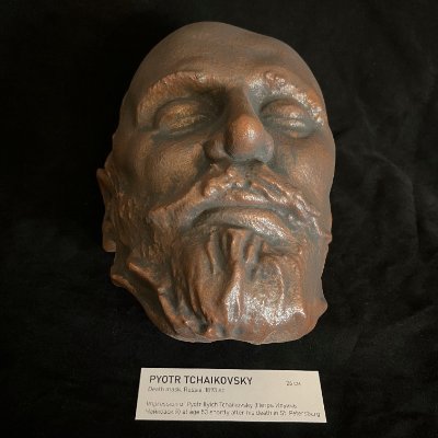 Direct frontal view of the Tchaikovsky reproduction resting above its museum display tag.