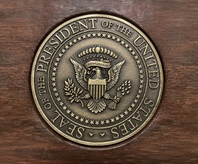 Direct, face-on view of the highly detailed bronze replica of the Seal of the President.