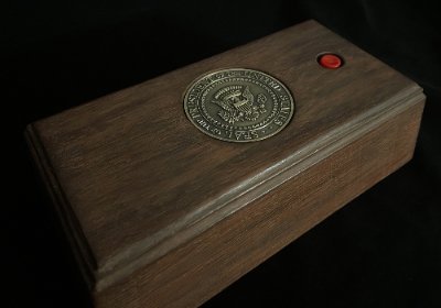 Full isometric view of the replica call box against a black background, showing dark wood stain.