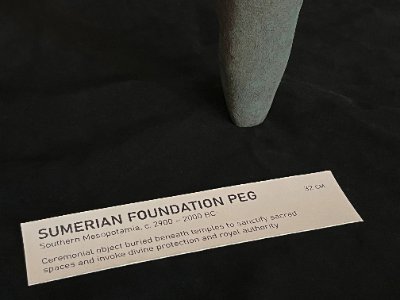 Close-up of the tapered peg base alongside museum display tag.