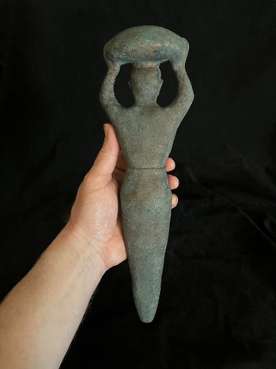 Full-length view of the Sumerian peg replica held upright in a hand.