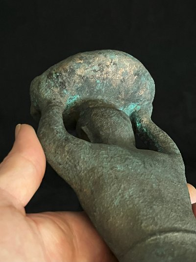 Direct top-down view of the textured basket resting on the figure's head.