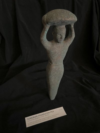 Angled perspective of the standing replica highlighting its tapered lower body.