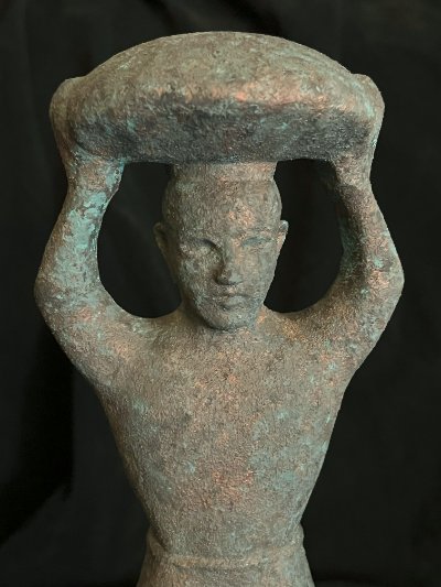 Frontal close-up of the face and carrying basket on the replica peg.