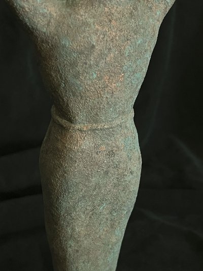 Detail of the midsection where the human torso transitions into the solid peg.