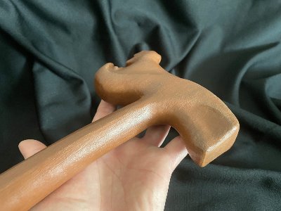 Close-up from the rear angle showing the smooth carved curves of the replica gavel's head.