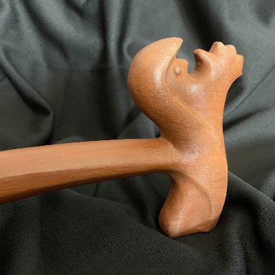 Close-up profile of the intricately carved head on the replica UN General Assembly gavel.