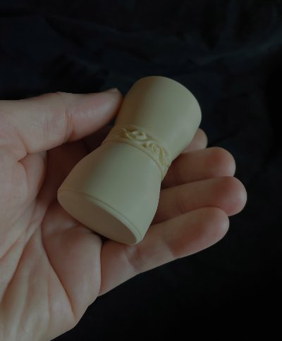 A hand grasps the U.S. Senate replica gavel to showcase the grip of its handleless design.