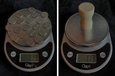 Two digital scales compare a pile of coins weighing 114 grams to the replica gavel weighing 113 grams.