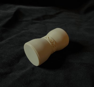 The handleless U.S. Senate replica gavel rests on its side to display its contoured hourglass profile.