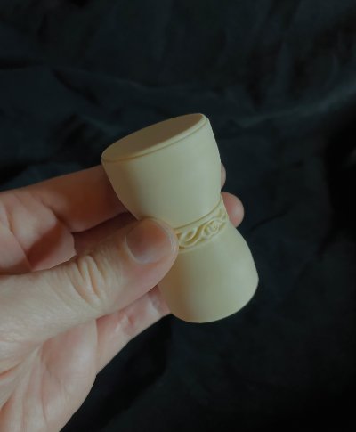 A hand holds the U.S. Senate replica gavel upright to demonstrate its physical scale and total width.